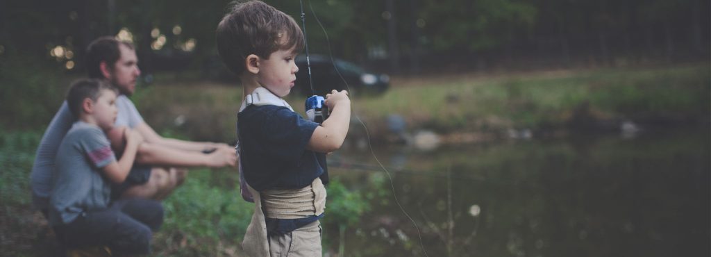 A child fishing by the pond