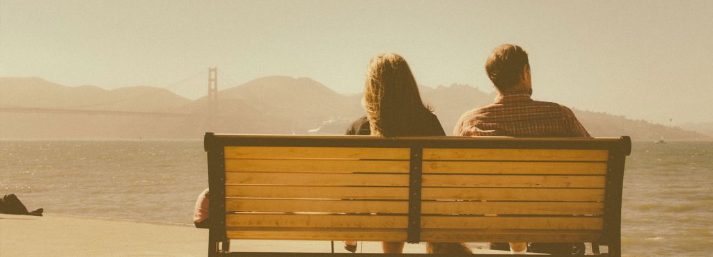 A couple sitting on a bench in San Francisco