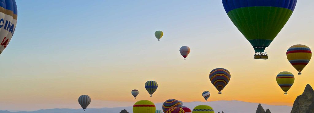 Balloons flying in a colourful sky