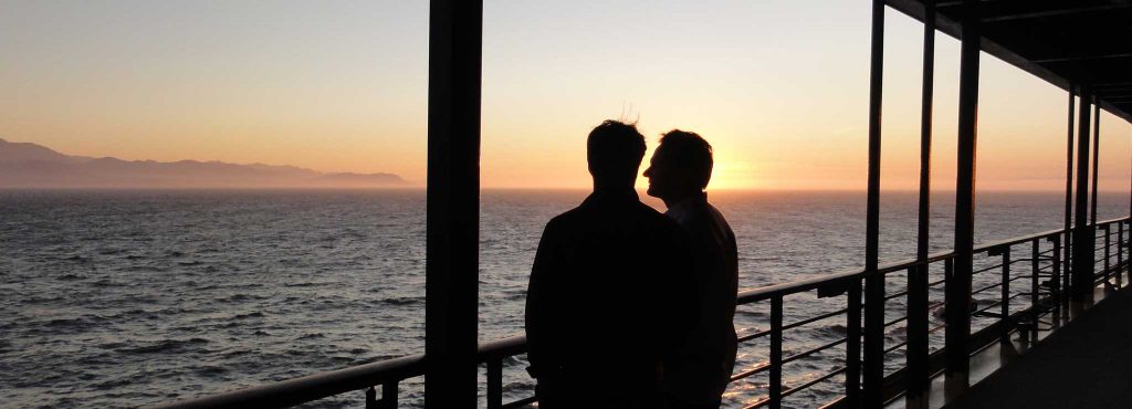 Two men speaking while on a pier