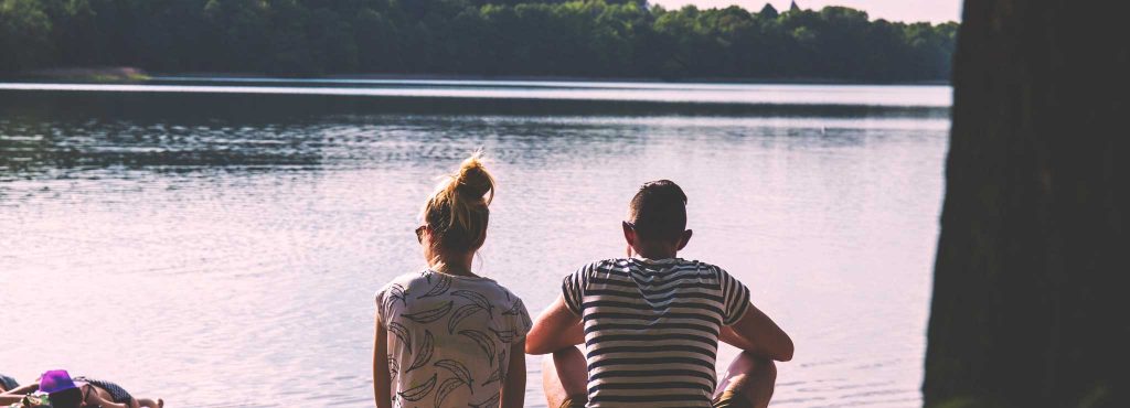 A couple sitting by the river