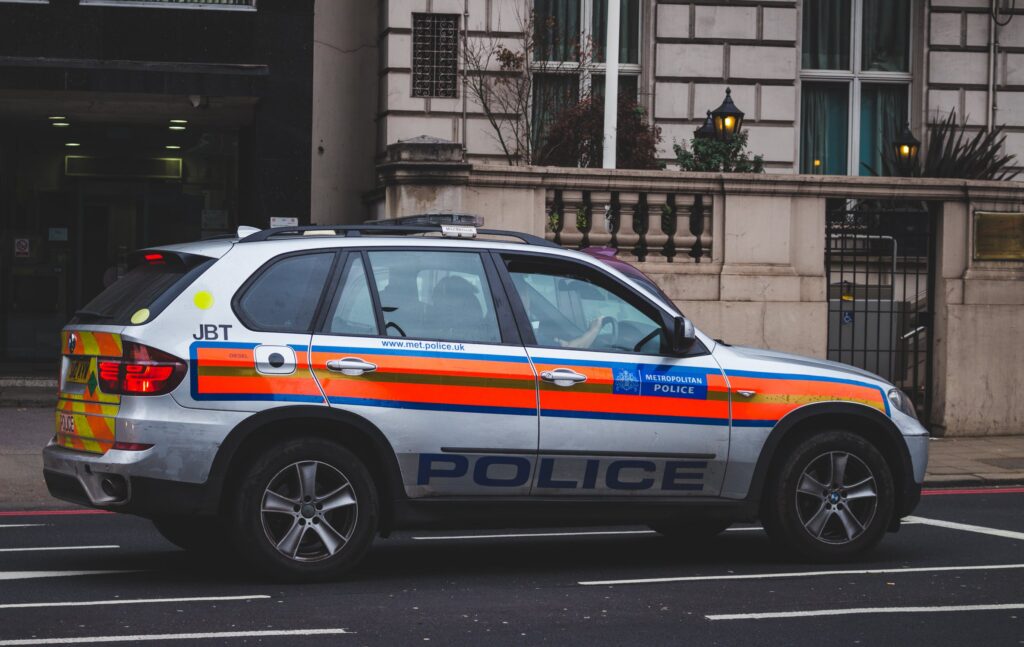A photo of a British police car parked on the street.