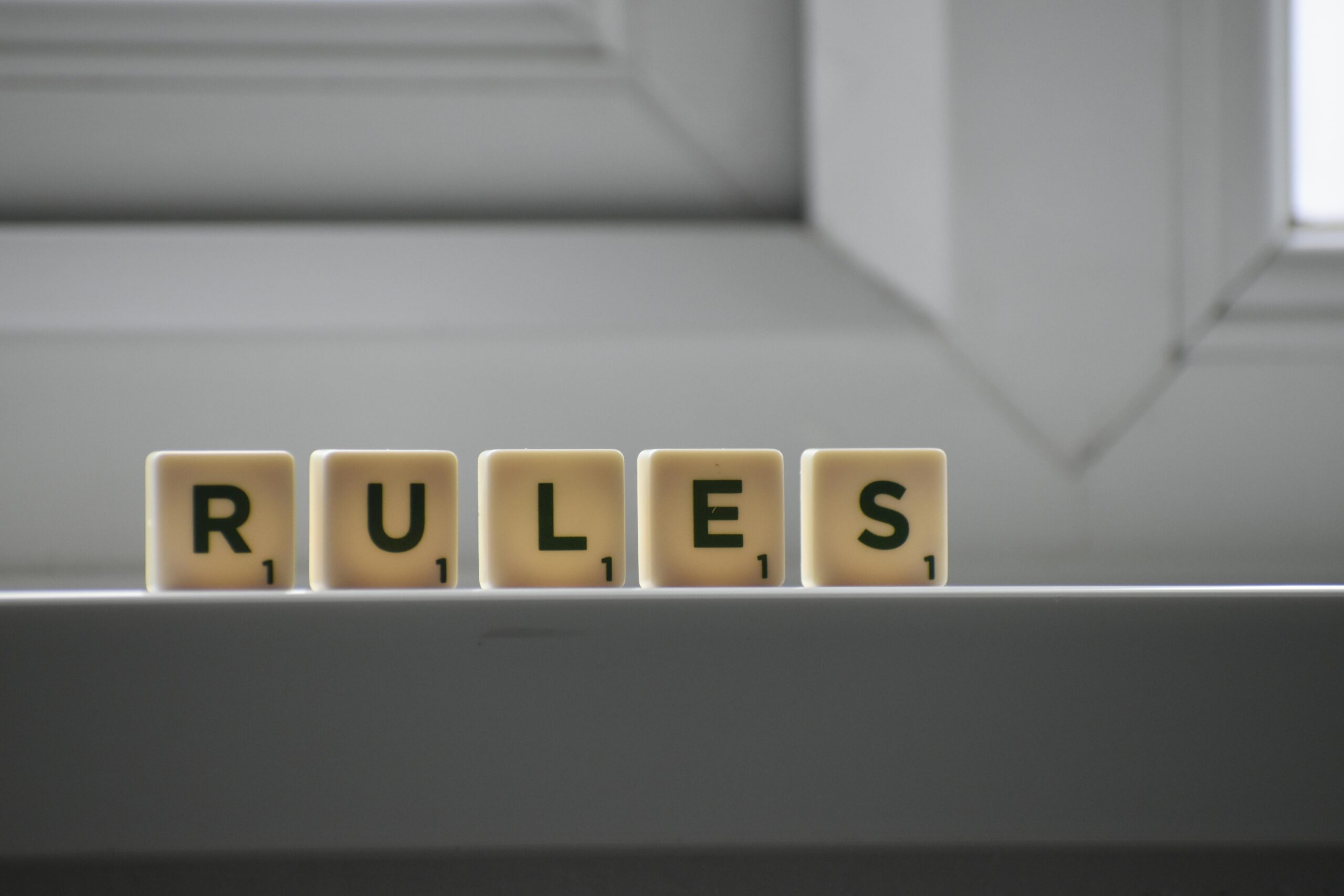 "rules" spelled out with individual wooden boxes